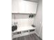 Functional mudroom area featuring white cabinets, bench seating, and storage cubbies for shoes and accessories at 5103 Covington Ave, McCordsville, IN 46055