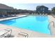 Community pool with lounge chairs and a relaxing environment surrounded by well-maintained landscaping and neighborhood houses at 5103 Covington Ave, McCordsville, IN 46055