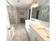 Bright bathroom featuring double sink vanity, a large mirror, and glass enclosed shower at 520 Ferndale Ln, Danville, IN 46122