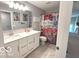 Bathroom featuring a double vanity, a large mirror, and a shower with a unique curtain at 520 Ferndale Ln, Danville, IN 46122