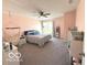 Spacious bedroom with a ceiling fan, playful decor, and a large window for natural light at 520 Ferndale Ln, Danville, IN 46122