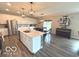 This open-concept kitchen features an island, stainless steel appliances, and white cabinetry at 520 Ferndale Ln, Danville, IN 46122