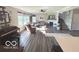 Sun-filled living room featuring hardwood floors, neutral decor, and a fireplace at 520 Ferndale Ln, Danville, IN 46122