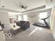 Expansive living room featuring a comfortable sofa, a treadmill, and a glimpse into the bedroom at 520 Ferndale Ln, Danville, IN 46122