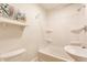 Bright white bathroom with shower over tub and pedestal sink at 525 Orange St, Indianapolis, IN 46203