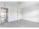 A bedroom with gray carpet, white walls, and a door to the hallway at 525 Orange St, Indianapolis, IN 46203