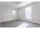 Bedroom with neutral carpet, white walls, a ceiling fan, and two windows at 525 Orange St, Indianapolis, IN 46203