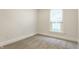 Neutral carpeted bedroom with window letting in natural light at 525 Orange St, Indianapolis, IN 46203