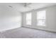 Light filled bedroom with neutral carpet, ceiling fan, and two windows at 525 Orange St, Indianapolis, IN 46203