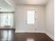 Bright entryway with hardwood floors, featuring a stylish door and a glimpse of the living area at 525 Orange St, Indianapolis, IN 46203