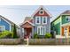 Charming two-story home featuring a colorful exterior, well-maintained lawn, and inviting front porch at 525 Orange St, Indianapolis, IN 46203