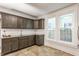 Kitchen features dark cabinets, granite countertops, and natural light from two windows at 525 Orange St, Indianapolis, IN 46203