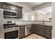 Kitchen features stainless steel appliances, granite countertops and dark cabinets at 525 Orange St, Indianapolis, IN 46203