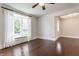 Bright living room featuring hardwood floors, large bay window, and easy access to other rooms at 525 Orange St, Indianapolis, IN 46203