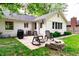Spacious backyard features a patio with chairs and a grill, perfect for outdoor entertaining at 535 Radburn Dr, Indianapolis, IN 46214