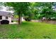 Expansive backyard with lush green grass, a shed, and a patio with chairs, ideal for recreation at 535 Radburn Dr, Indianapolis, IN 46214