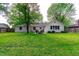 Spacious backyard featuring lush green grass and a charming patio seating area at 535 Radburn Dr, Indianapolis, IN 46214