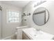Updated bathroom featuring a modern vanity, stylish mirror, and a shower with a neutral-patterned shower curtain at 535 Radburn Dr, Indianapolis, IN 46214