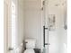 Modern bathroom showcasing a tiled shower with a glass door and natural light at 535 Radburn Dr, Indianapolis, IN 46214