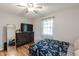 Cozy bedroom with a dark wood dresser, mirrored accent, wood floors, and a comfortable bed at 535 Radburn Dr, Indianapolis, IN 46214