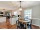 Cozy dining area featuring a wooden table and chandelier open to living area at 535 Radburn Dr, Indianapolis, IN 46214