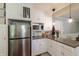 Kitchen featuring a stainless steel refrigerator, granite countertops and white cabinetry at 535 Radburn Dr, Indianapolis, IN 46214