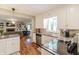 Well-lit kitchen area featuring white cabinetry, stainless appliances, and a dining area at 535 Radburn Dr, Indianapolis, IN 46214