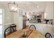 Cozy kitchen with white cabinets, stainless steel appliances and a dining area at 535 Radburn Dr, Indianapolis, IN 46214