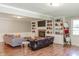 Comfortable living room featuring a fireplace with built-in bookshelves, hardwood floors, and comfortable sofas at 535 Radburn Dr, Indianapolis, IN 46214