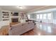 Spacious living room boasts a fireplace with built-ins, wood floors, large windows, and comfortable seating at 535 Radburn Dr, Indianapolis, IN 46214