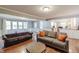 Inviting living room with hardwood floors, comfortable seating, large windows, and open access to the kitchen at 535 Radburn Dr, Indianapolis, IN 46214