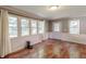 Bright sun room with hardwood floors, multiple windows, and natural light offering a cozy place to relax at 535 Radburn Dr, Indianapolis, IN 46214