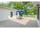 Charming back deck with door to the house, table, chairs and a bright blue umbrella at 59 Sycamore Dr, Carmel, IN 46033