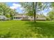 Expansive backyard featuring a large lawn, mature trees, and a spacious deck perfect for outdoor entertaining at 59 Sycamore Dr, Carmel, IN 46033