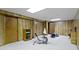 Finished basement featuring wood-paneled walls, neutral carpet, and an exercise bike at 59 Sycamore Dr, Carmel, IN 46033