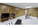 Finished basement featuring wood-paneled walls, neutral carpet, and workout area at 59 Sycamore Dr, Carmel, IN 46033