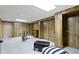 Finished basement featuring wood-paneled walls, neutral carpet, and workout area at 59 Sycamore Dr, Carmel, IN 46033
