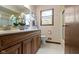 This bathroom includes a double sink vanity and a window for natural lighting at 59 Sycamore Dr, Carmel, IN 46033