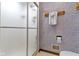 This bathroom features a glass shower door, a towel rack with a towel, and lavender wall design at 59 Sycamore Dr, Carmel, IN 46033