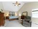 Vaulted ceiling bedroom with a ceiling fan, carpeted floors, and comfortable armchair at 59 Sycamore Dr, Carmel, IN 46033