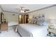 Well-lit bedroom with neutral colors, a ceiling fan, and view to the en-suite bathroom at 59 Sycamore Dr, Carmel, IN 46033