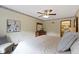 Inviting bedroom with a ceiling fan, wall art, and view to the en-suite bathroom at 59 Sycamore Dr, Carmel, IN 46033