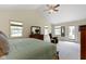Vaulted ceiling primary bedroom with a ceiling fan, carpeted floors, and walkout to patio at 59 Sycamore Dr, Carmel, IN 46033