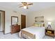 This bedroom features a wood dresser and a window bringing in natural light at 59 Sycamore Dr, Carmel, IN 46033