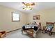 This cozy bedroom includes a ceiling fan, a window, and a vintage rocking chair at 59 Sycamore Dr, Carmel, IN 46033