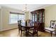 Traditional dining room with hardwood floors, chandelier, large window, and mahogany china cabinet at 59 Sycamore Dr, Carmel, IN 46033