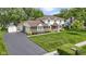 Charming two-story home with brick and siding, a well-manicured lawn, mature trees, and an attached two-car garage at 59 Sycamore Dr, Carmel, IN 46033