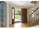 Inviting foyer featuring hardwood floors, a staircase, and an open view of the front lawn at 59 Sycamore Dr, Carmel, IN 46033