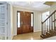 Warm foyer with hardwood floors and a striking front door featuring decorative glass sidelights at 59 Sycamore Dr, Carmel, IN 46033