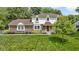 Well-maintained home exterior with lush green lawn, mature trees, and manicured landscaping at 59 Sycamore Dr, Carmel, IN 46033